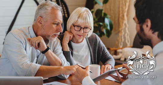 Attorney explaining paperwork to elderly retired couple
